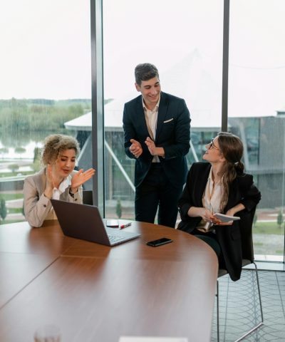 Team of professionals collaborating in an office setting, showcasing a successful meeting.
